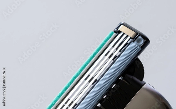 Obraz Close-Up of Triple Blade Razor Head on Light Background - Shaving Tool Macro