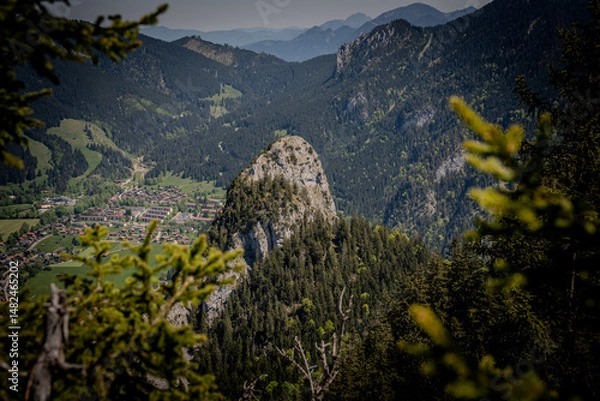 Fototapeta Majestic Kofel Mountain In Oberammergau: Towering Rocky Peak Surrounded By Dense Alpine Forests And Overlooking The Picturesque Bavarian Village In The Heart Of The Lush Bavarian Alps