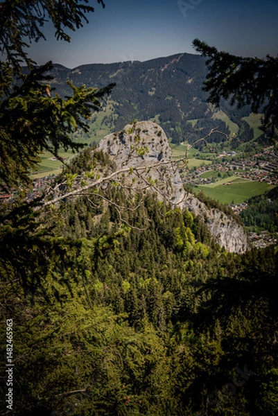 Fototapeta Majestic Kofel Mountain In Oberammergau: Towering Rocky Peak Surrounded By Dense Alpine Forests And Overlooking The Picturesque Bavarian Village In The Heart Of The Lush Bavarian Alps