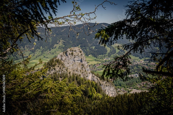 Fototapeta Majestic Kofel Mountain In Oberammergau: Towering Rocky Peak Surrounded By Dense Alpine Forests And Overlooking The Picturesque Bavarian Village In The Heart Of The Lush Bavarian Alps