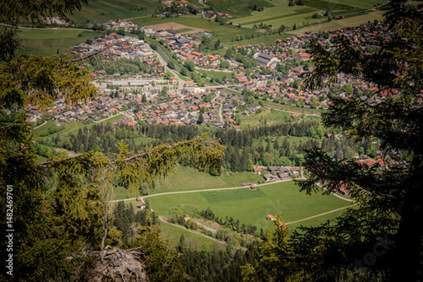 Fototapeta Stunning Aerial View Of Oberammergau Town: Picturesque Bavarian Village Nestled Between Lush Green Meadows, Dense Forests, And Majestic Rocky Peaks In The Scenic Ammergau Alps Region