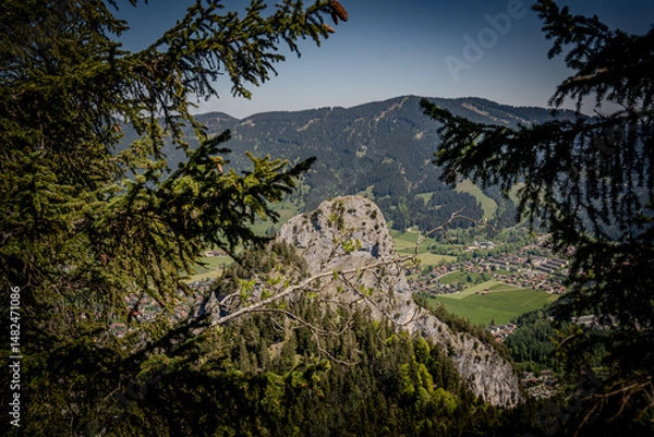Fototapeta Majestic Kofel Mountain In Oberammergau: Towering Rocky Peak Surrounded By Dense Alpine Forests And Overlooking The Picturesque Bavarian Village In The Heart Of The Lush Bavarian Alps