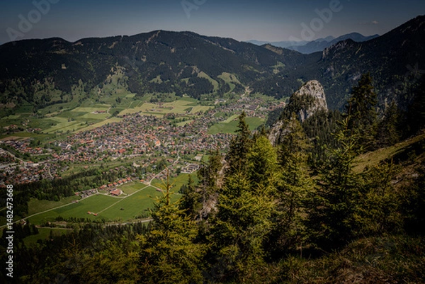 Fototapeta Majestic Kofel Mountain In Oberammergau: Towering Rocky Peak Surrounded By Dense Alpine Forests And Overlooking The Picturesque Bavarian Village In The Heart Of The Lush Bavarian Alps