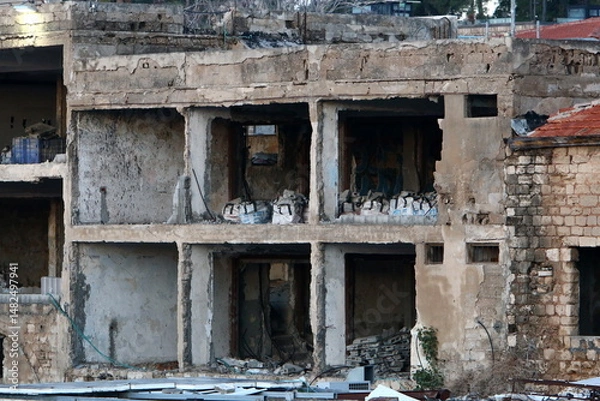 Fototapeta Ruins of old houses in the center of a big city