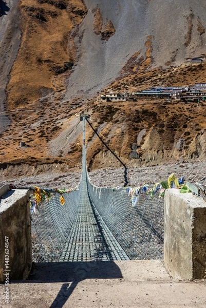 Obraz New long suspension bridge on the trekking route to Thorung Phedi. Annapurna circuit trek, Himalaya, Nepal.