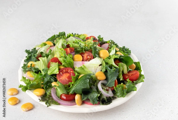 Obraz Green salad with fresh vegetables and lupine beans on white background. Vegetarian food.