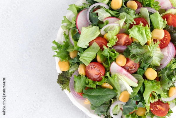 Obraz Green salad with fresh vegetables and lupine beans on white background. Close-up. Vegetarian food.