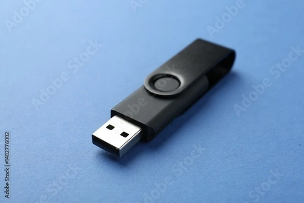 Obraz One flash drive on blue background, closeup