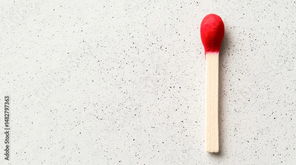 Obraz Single matchstick with red tip on a grey surface, minimalistic and modern.