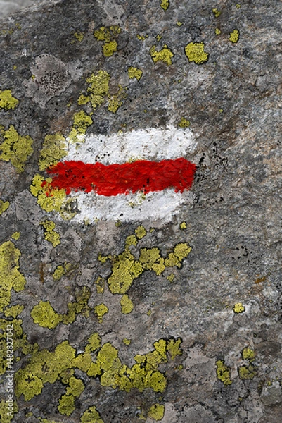 Obraz Mountain hiking trail sign with lichens on the rocks