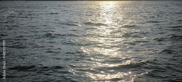 Fototapeta Water waves and evening light for background