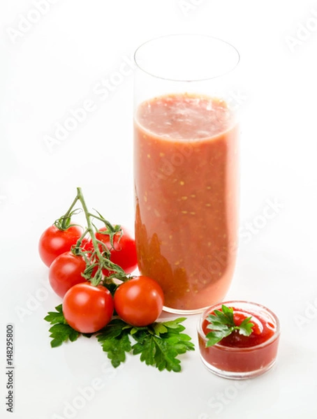 Fototapeta Composition from a tomato and a glass of juice on a white background.