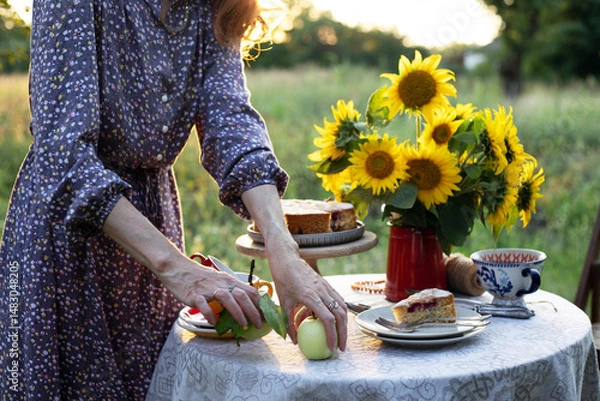 Obraz girl serving tea table in the garden
