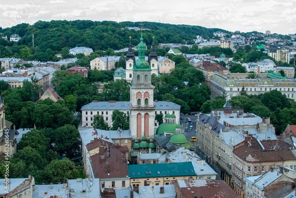 Obraz From above the picturesque cityscape of Lviv Ukraine unfolds revealing its old buildings diverse architecture and notable towers surrounded by trees 
