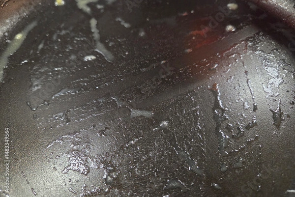 Fototapeta Nonstick Frying Pan Surface with Oil Residue in Kitchen Setting for Cooking Concepts