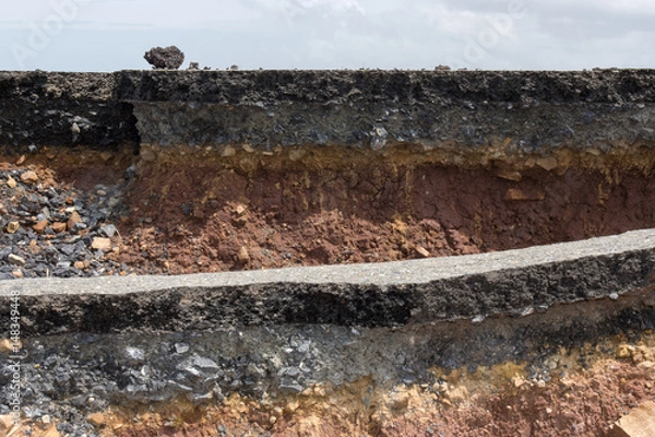 Fototapeta Side of the broken asphalt road collapsed and fallen
