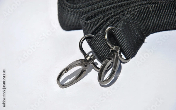 Fototapeta bag strap with carabiners on a light background
