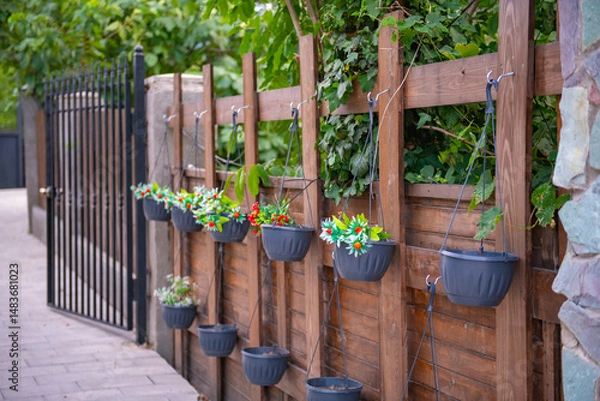 Obraz flower pots hanging on a fence in Mtskheta