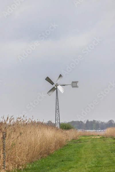 Fototapeta Nature Landscape with small windmill along Burgumer lake in Friese wouden bij Eastermar in The Netherlands