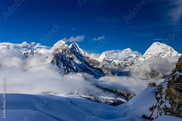 Fototapeta Mera Peak high altitude mountain summit ascent in Himalayas. Stunning views above the clouds at sunrise from the top of the mountain. Alpine route climbing on the snow path in Himalayas