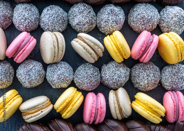 Obraz Macarons and coconut balls in order on plate