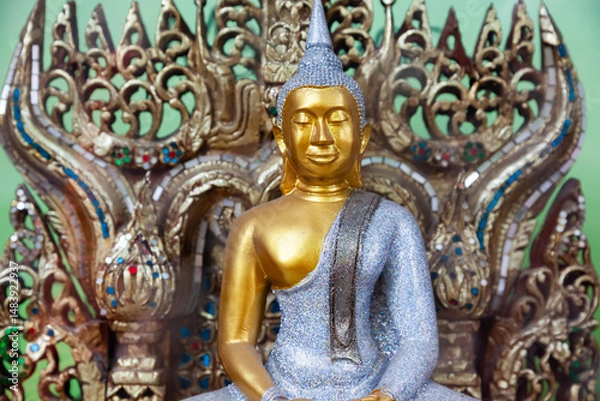 Obraz Gilded figure of Buddha on a throne.