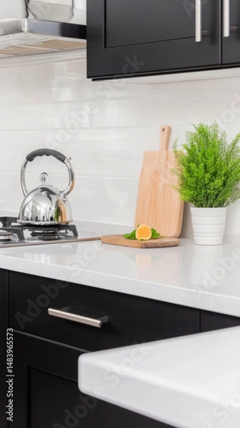 Fototapeta Elegant modern kitchen with charcoal cabinets and white countertop