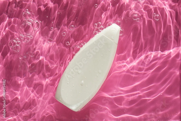 Obraz Blank dispenser bottle of cosmetics in water on pink background view from above. Copy space