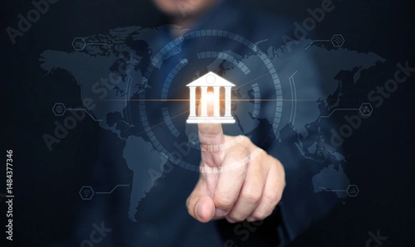 Fototapeta Online digital banking and financial technology concept: A man taps on bank icon to accesses mobile transactions worldwide