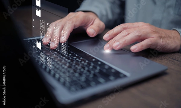 Fototapeta Document Management System concept. A man using DMS software on his laptop to store, share, track and manage files or documents.
