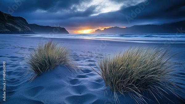 Fototapeta A serene beach scene at sunset, featuring gentle waves lapping against the shore.