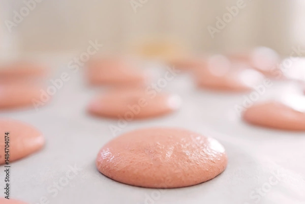 Fototapeta Close-up of pink macarons batter resting on a baking sheet