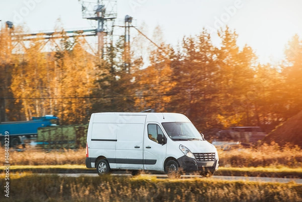 Fototapeta Delivery van driving on open road