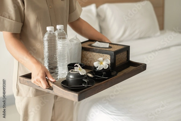 Obraz The housekeeper hotel cleans and arranges things in order. prepares to welcome VIP guests
