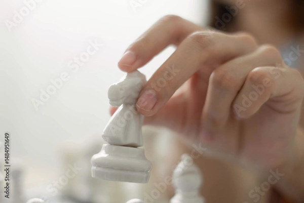 Obraz hand of businessmen moving chess in competition shows leadership, followers and business success strategies