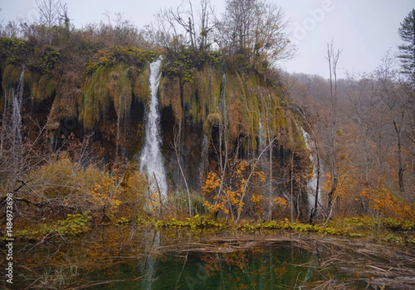 Fototapeta Plitvice Lakes in Croatia during autumn, showcasing stunning waterfalls, vibrant foliage, and crystal-clear waters, creating a magical and serene natural landscape perfect for nature lovers.