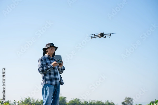 Fototapeta Agronomist Using Technology in Agricultural Corn Field. Drone flying over green corn fields.