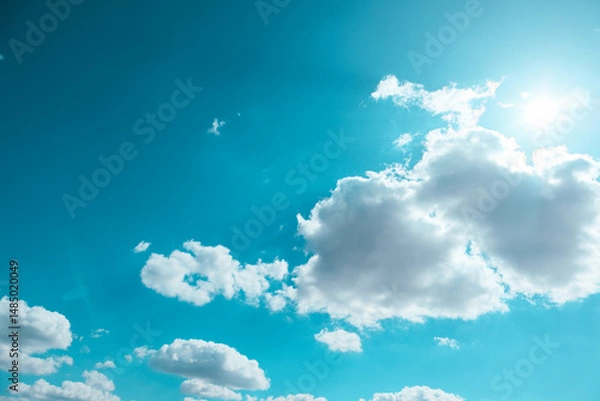Obraz Blue sky and clouds in sunny day. Clear blue sky with faint, fluffy white clouds scattered lightly.