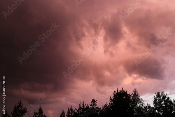 Obraz Fiery red storm clouds with dramatic lighting. Red storm clouds background. Dramatic red sky.