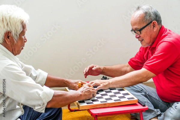 Obraz Portrait Of Two Asian Senior Men Setting Up The Chessboard
