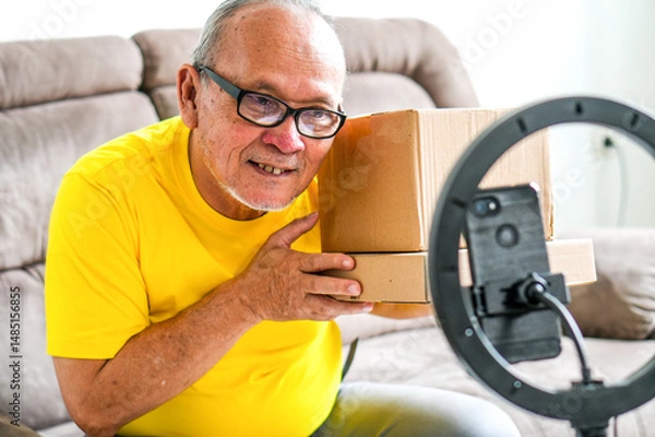 Obraz Elderly Male Influencer Ready to Opening His Online Delivery Box, Vlogger Creating Internet Video Content