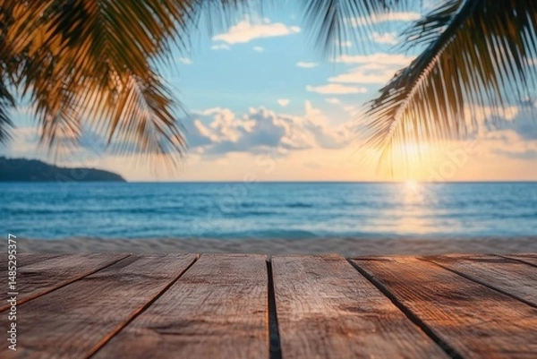 Fototapeta Serene sunset view over calm ocean with wooden deck foreground framed by palm leaves