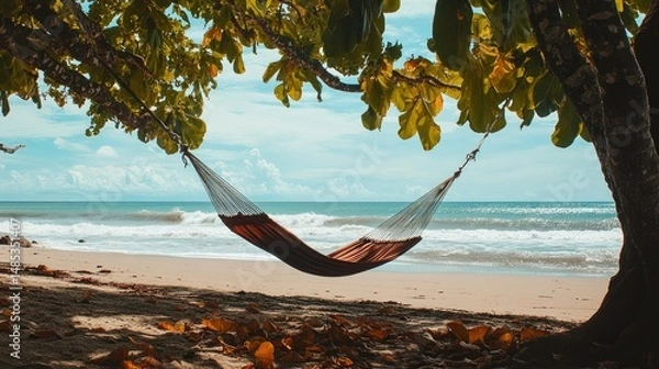 Fototapeta Tropical beach scene featuring a hammock suspended between two trees