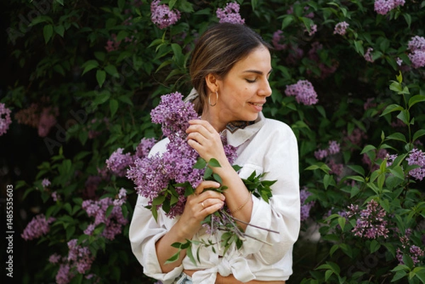 Obraz Woman Embraces Fragrant Lilac Blooms In Spring