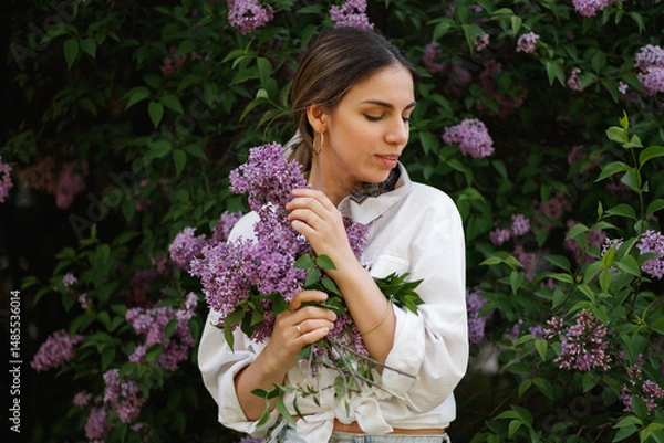 Obraz Woman Embraces Fragrant Lilac Blooms In Spring