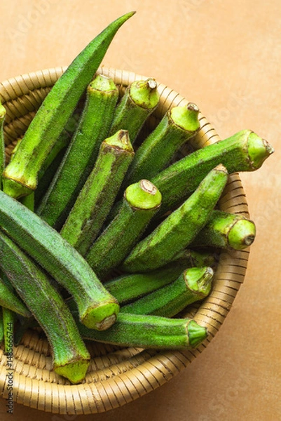 Fototapeta Okra is a vegetable originally from Africa, used in cuisines such as Caribbean, Creole, Cajun and Indian. It's also known as bhindi or lady's fingers.  Africa cuisine, close up
