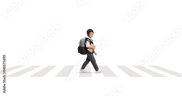 Fototapeta Asian schoolboy in a uniform walking at a zebra crossing and holding a book