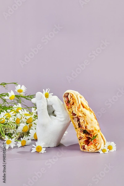 Fototapeta Stack is hybrid of taco, burrito and quesadilla, wrapped in tortilla and filled with beef or chicken, tomatoes, cheese and lettuce. Mexican-American dish