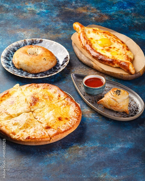 Fototapeta Khachapuri with cheese, savory open or closed pie with cheese and egg, traditional Georgian dish from the Caucasus region