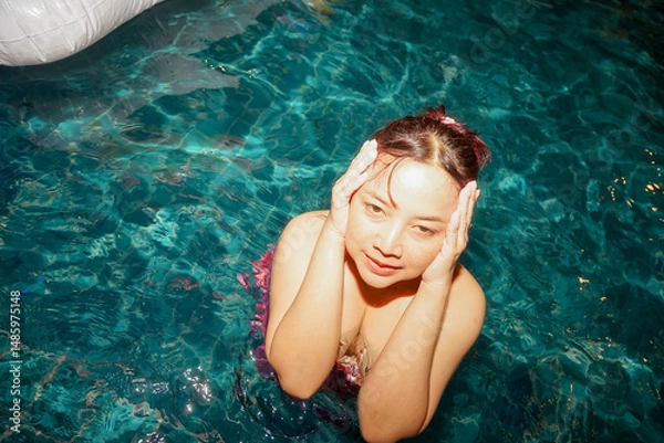 Fototapeta Portrait of beautiful woman in swimwear relaxing in swimming pool spa. 
